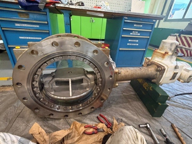 KSB Amri butterfly valve removed for service, showing the metal seal flange face